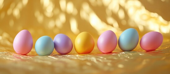 Wall Mural - Colorful Easter eggs arranged in a row on a textured golden foil background creating a festive and cheerful atmosphere.