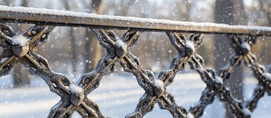 Wall Mural - forged metal lattice covered in snow with selective focus showcasing winter beauty and intricate des