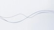 © Elena - Delicate grey ribbon gracefully undulating against a white background, showcasing smooth curves and fluid movement
