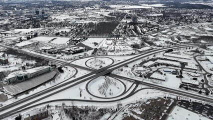 Wall Mural - Drone view of Deerfoot Trail Freeway in snow-covered urban landscape during winter in Waterloo