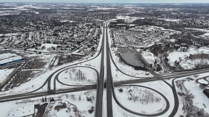 Wall Mural - Drone view of Deerfoot Trail Freeway in snow-covered urban landscape during winter daytime