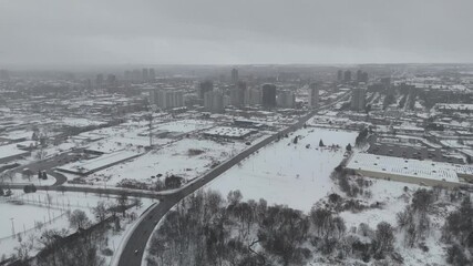 Wall Mural - A highway through ice-covered city with high-rise buildings and foggy sky in the background