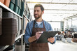 © zinkevych - Male garden center worker in plants pot department making notes