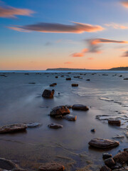 Wall Mural - long exposure view of rocky seascape at dusk.