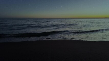 Wall Mural - waves crashing against the seashore at night