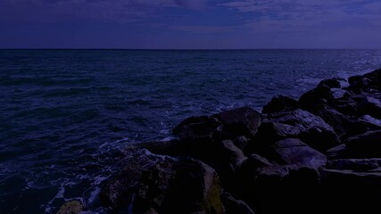 Wall Mural - waves crashing against the seashore at night
