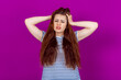 © Red Cristal - Shocked Young Woman Gripping Her Head and Pulling Hair in Distress and Disbelief. Shock, Surprise, and Emotional Turmoil in Response to Unexpected News or Events