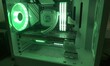 © Resni AI - White PC case with green LED lighting, custom built gaming computer