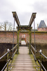 Wall Mural - Wooden draw bridge leading to side entrance exterior facade wall of moated Kasteel Doorwerth