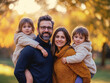 © Shyla Marsare - Familia feliz en un parque en otoño. Gente con hijos en exterior. Familia en el parque pasándolo genial.
