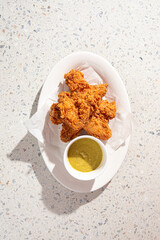 Wall Mural - Portion of golden fried chicken with sauce in the cafe