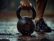 © INT888 - strong grip on kettlebell in rainy workout setting