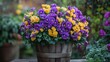 © Santy Hong - A beautiful floral arrangement featuring purple and yellow blossoms in a rustic wooden bucket, set in an outdoor garden