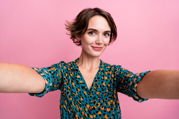 Wall Mural - Photo of gorgeous pleasant girl with bob hairstyle dressed stylish shirt making selfie on frontal camera isolated on pink color background