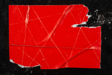 Poster - Red torn poster. Old poster on a bulletin board.