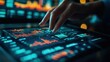 © Endin - Close-up of a hand interacting with a tablet displaying financial data and charts.