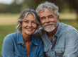 © INVO - A joyful senior couple sits together on the grass in a beautiful outdoor park, smiling and embracing each other. The warm natural lighting enhances the serene and loving atmosphere,