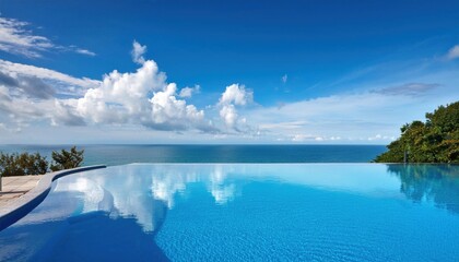 Wall Mural - vibrant summer day by the infinity pool overlooking a tranquil ocean
