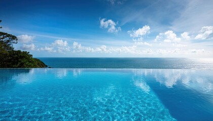 Wall Mural - enjoying vibrant summer days by the stunning ocean view pool under a bright blue sky
