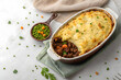 © Anusa - Hearty Shepherd's Pie with Peas and Carrots on Rustic Table