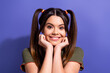 © deagreez - Smiling young woman with ponytails posing against violet background in casual attire