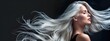 © Umar - Portrait of a beautiful young woman with long straight shiny healthy white hairs looking at the camera with hair tossing in the air, isolated on black background, salon cosmetic shampoo, conditioner