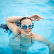 © Caroline - A woman swims in a pool wearing goggles