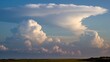Majestic cloud formations display a stunning gradient of whites and blues against a serene sky, creating a tranquil and awe-inspiring atmosphere.