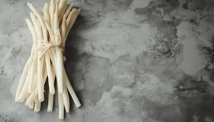 Wall Mural - Pile of fresh white asparagus on grey table, closeup