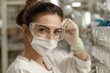 © Oleksandra - Female scientist with protective eyewear and face mask closely examining samples in a laboratory environment during research work