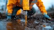 © DachAI - A close-up of a groundwater sampling drill extracting water from the wet soil, capturing the action and the technique involved in assessing environmental conditions effectively.