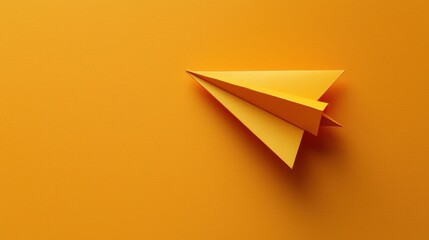 Wall Mural - A yellow paper airplane on a vibrant orange background.