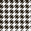 © Mira - Seamless houndstooth pattern. Classic plaid design. It is characterized by a pattern of alternating squares resembling a scattered star in two colors.