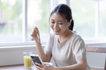 Poster - 朝食を食べながらスマホを見る女性