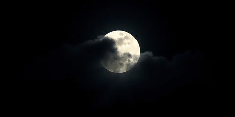 Wall Mural - A full moon partially obscured by clouds in a dark night sky