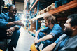 © Davor - Warehouse workers taking a break sitting near forklift in storage facility