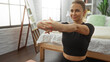 © Krakenimages.com - Woman stretching on the floor of a cozy bedroom with natural light, featuring a welcoming atmosphere, short blonde hair, and a focus on well-being and relaxation.