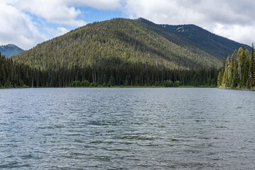 Wall Mural - Beautiful waters of the Lightning Lake at Manning Park British Columbia Canada with clouds over the mountains