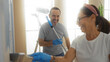 © Krakenimages.com - Hispanic couple painting their new home together, enjoying the process in a bright living room, showcasing love and teamwork while renovating their apartment.