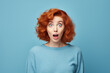© jeewanthisandalanka - Astonished Caucasian Woman Pointing Away on Blue Background