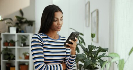 Poster - House, thinking and woman with smartphone, typing and internet with connection, ideas and choice. Person, apartment and girl in lounge, cellphone and mobile app for email, online reading and network