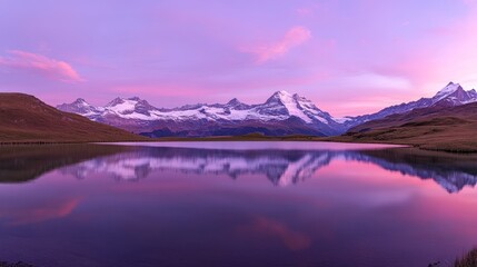 Wall Mural - Serene alpine lake reflecting snow-capped mountains at sunrise.