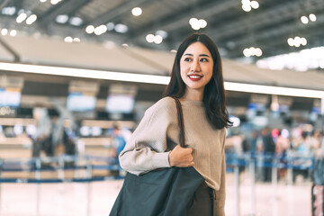 Wall Mural - Portrait of standing tourist woman at international airport terminal for departure with airline transport