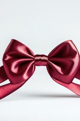 Sticker - A single red bow tie lying on a white surface, ideal for close-up shots or still life compositions