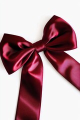 Wall Mural - A red ribbon tied to a bow on a white surface, great for wrapping presents or decorating events