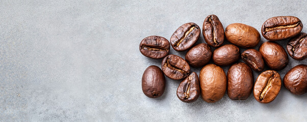 Roasted coffee beans on gray background. Culinary concept. Coffee shop, cafe, restaurant. Top view background for menu, print, poster, banner, flyer. Copy space.