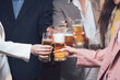© Kritdanai - Cheers to Collaboration: A diverse group of colleagues raise their glasses in a celebratory toast, symbolizing teamwork, camaraderie, and shared success.