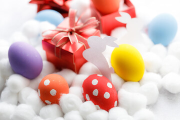 Wall Mural - Happy Easter eggs and gift boxes on white background. Easter decoration.