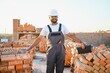 © Serhii - Indian Construction worker in uniform and safety equipment have job on building