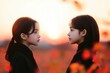 © vinod - two young women face each other during sunset in a field
